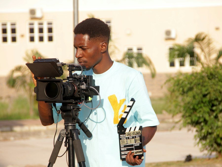 A filmmaker recording a video outdoors